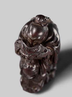 Lot 132 - HIDEMASA: A WOOD NETSUKE DEPICTING A CHINESE MAN SCARING A KARAKO