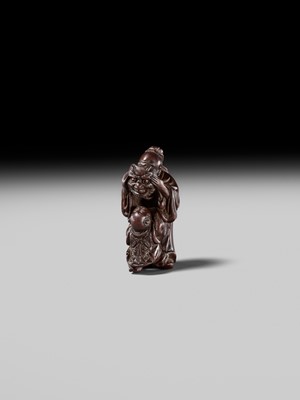 Lot 132 - HIDEMASA: A WOOD NETSUKE DEPICTING A CHINESE MAN SCARING A KARAKO