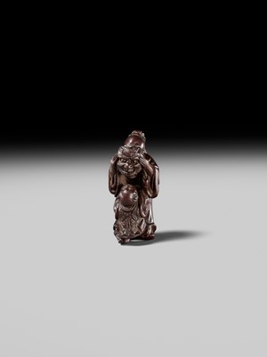 Lot 132 - HIDEMASA: A WOOD NETSUKE DEPICTING A CHINESE MAN SCARING A KARAKO
