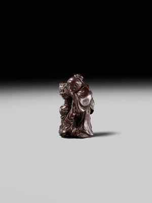 Lot 132 - HIDEMASA: A WOOD NETSUKE DEPICTING A CHINESE MAN SCARING A KARAKO