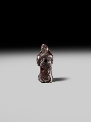 Lot 132 - HIDEMASA: A WOOD NETSUKE DEPICTING A CHINESE MAN SCARING A KARAKO
