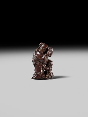 Lot 132 - HIDEMASA: A WOOD NETSUKE DEPICTING A CHINESE MAN SCARING A KARAKO