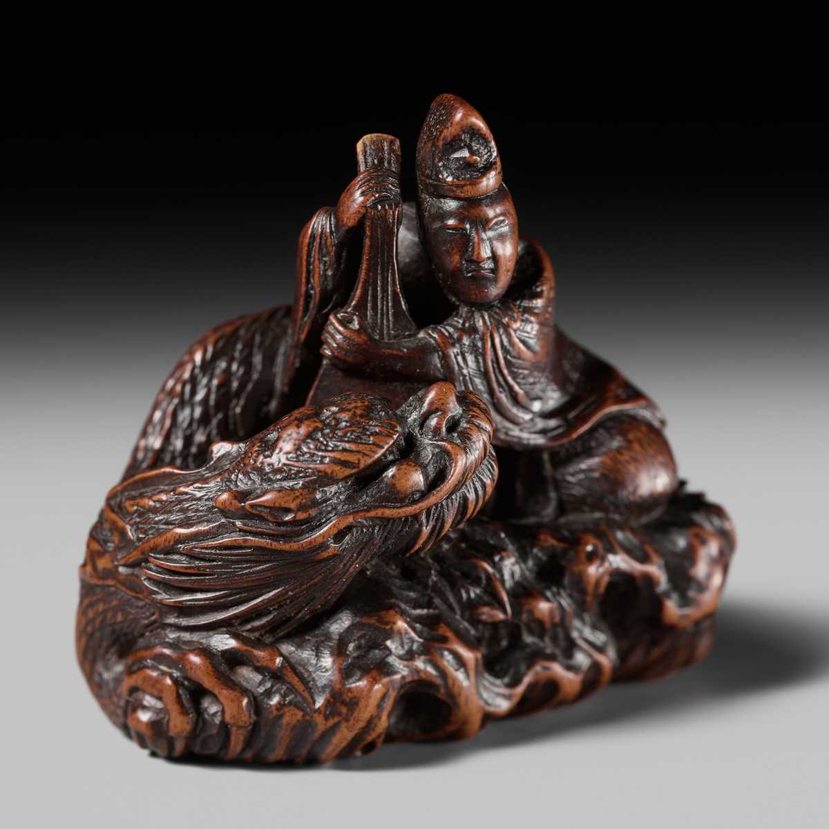 Lot 176 - MASAKAZU: A FINE NAGOYA SCHOOL WOOD NETSUKE DEPICTING TAIRA NO TSUNEMASA PLAYING THE BIWA