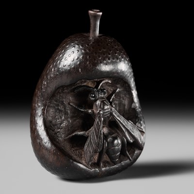 SANGETSU: A RARE EBONY WOOD NETSUKE OF A WASP IN A PEAR