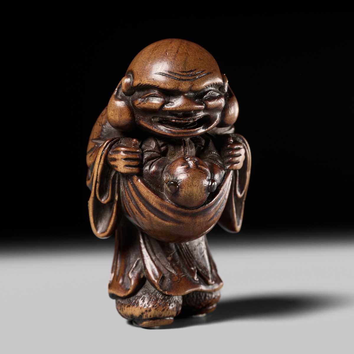 Lot 129 - AN EARLY OSAKA SCHOOL WOOD NETSUKE OF HOTEI AND A KARAKO