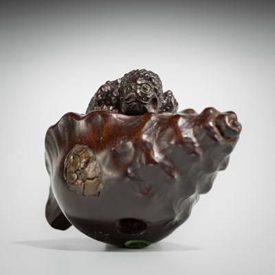 Lot 433 - KOMIN: A DARK WOOD NETSUKE OF A KAPPA EMERGING FROM A CONCH