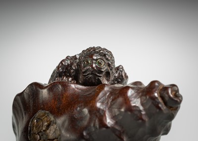 Lot 433 - KOMIN: A DARK WOOD NETSUKE OF A KAPPA EMERGING FROM A CONCH