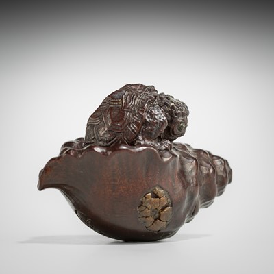 Lot 433 - KOMIN: A DARK WOOD NETSUKE OF A KAPPA EMERGING FROM A CONCH