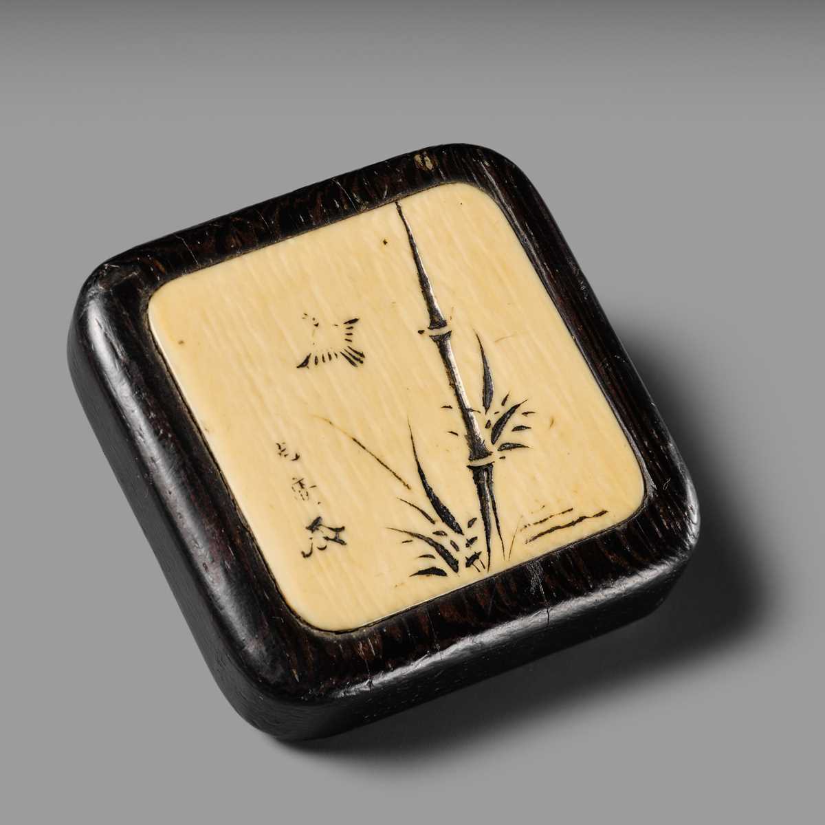 MITSUHIRO: A FINE WOOD AND IVORY MANJU NETSUKE DEPICTING A SPARROW AMONGST BAMBOO