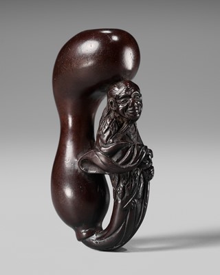 AN UNUSUAL WOOD NETSUKE OF TEKKAI SENNIN EMERGING FROM A HYOTAN (DOUBLE GOURD)