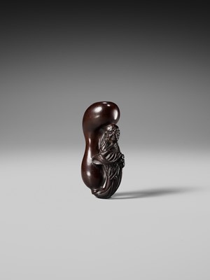 AN UNUSUAL WOOD NETSUKE OF TEKKAI SENNIN EMERGING FROM A HYOTAN (DOUBLE GOURD)