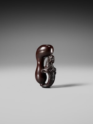 AN UNUSUAL WOOD NETSUKE OF TEKKAI SENNIN EMERGING FROM A HYOTAN (DOUBLE GOURD)
