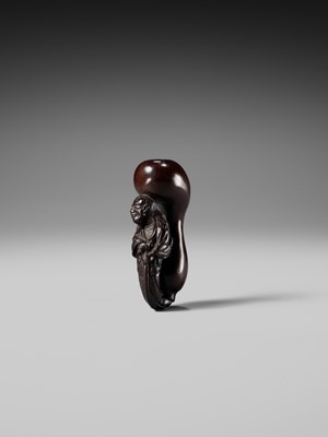 AN UNUSUAL WOOD NETSUKE OF TEKKAI SENNIN EMERGING FROM A HYOTAN (DOUBLE GOURD)