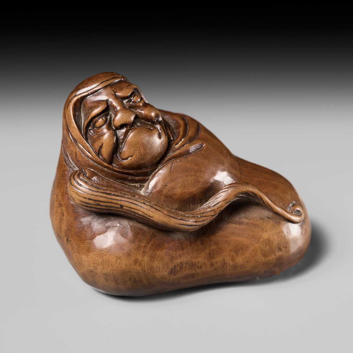 Lot 241 - NOBUSHIGE: A FINE AND RARE WOOD NETSUKE OF DARUMA DISTURBED IN HIS MEDITATION