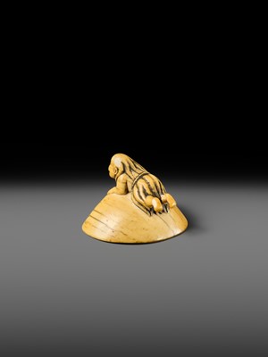 AN IVORY NETSUKE OF A FISHERGIRL (AMA) ON A LARGE CLAM