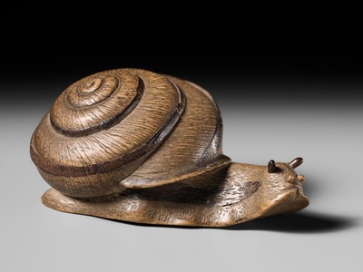 Lot 185 - YUZAN: AN UNUSUAL WOOD NETSUKE OF A SNAIL EMERGING FROM ITS SHELL