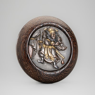 A SHIBUICHI AND WOOD KAGAMIBUTA NETSUKE WITH SHOKI