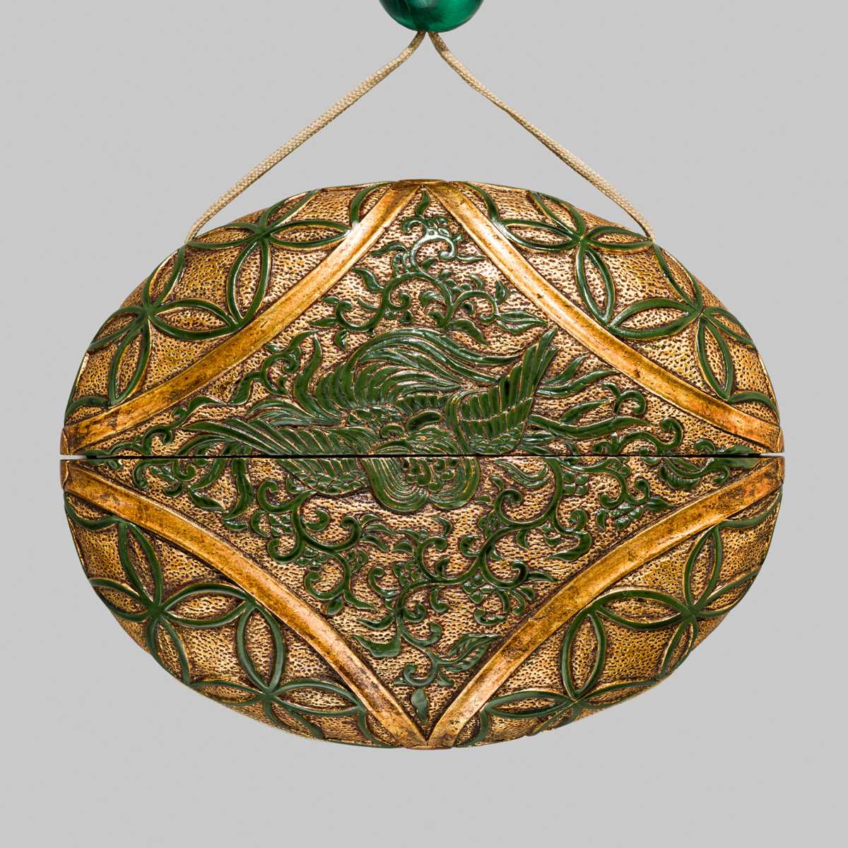 Lot 61 - A RARE LACQUERED ‘SIMULATED EUROPEAN LEATHER’ TONKOTSU WITH A HO-O