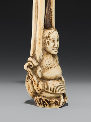 A LARGE AND IMPRESSIVE ANTLER KISERUZUTSU (PIPE CASE) OF TENAGA WITH AN OCTOPUS