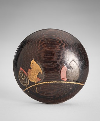 Lot 1760 - A LACQUERED WOOD MANJU NETSUKE