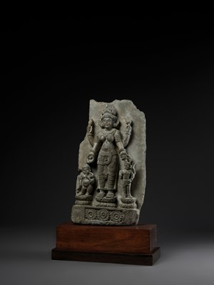 Lot 691 - AN IMPORTANT STONE STELE OF PARVATI WITH HER SONS GANESHA AND SKANDA