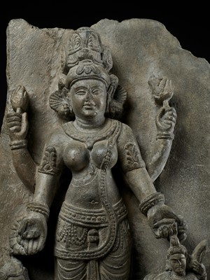 Lot 691 - AN IMPORTANT STONE STELE OF PARVATI WITH HER SONS GANESHA AND SKANDA