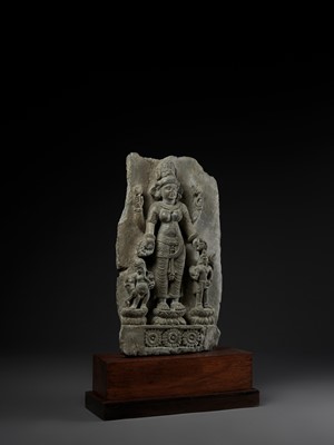 Lot 691 - AN IMPORTANT STONE STELE OF PARVATI WITH HER SONS GANESHA AND SKANDA