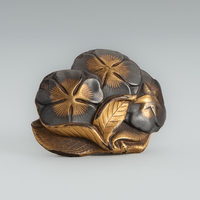 Lot 1756 - A GOLD AND SILVER LACQUERED WOOD MANJU NETSUKE WITH PLUM BLOSSOMS