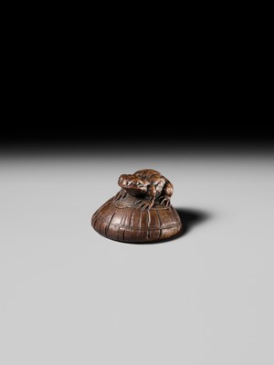 Lot 188 - ICHIMIN: A FINE NAGOYA SCHOOL WOOD NETSUKE OF A TOAD ON A KASA HAT