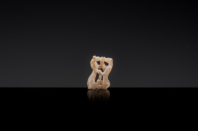 Lot 19 - A RETICULATED WHITE JADE MINIATURE PENDANT OF TWO FROLICKING TIGERS, WARRING STATES OR WESTERN HAN DYNASTY