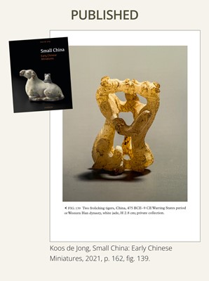 Lot 19 - A RETICULATED WHITE JADE MINIATURE PENDANT OF TWO FROLICKING TIGERS, WARRING STATES OR WESTERN HAN DYNASTY