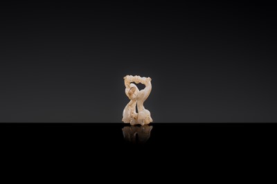 Lot 19 - A RETICULATED WHITE JADE MINIATURE PENDANT OF TWO FROLICKING TIGERS, WARRING STATES OR WESTERN HAN DYNASTY