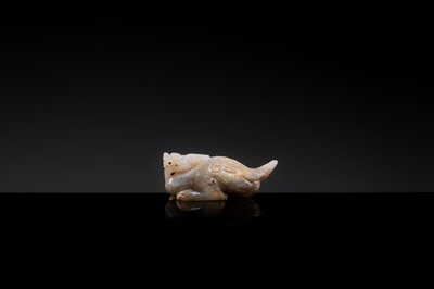 Lot 20 - A MOTTLED WHITE JADE CARVING OF A BIXIE, SIX DYNASTIES PERIOD