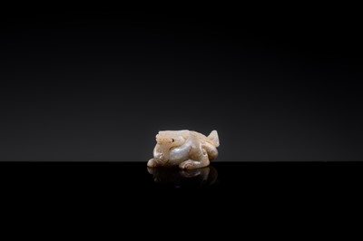 Lot 20 - A MOTTLED WHITE JADE CARVING OF A BIXIE, SIX DYNASTIES PERIOD