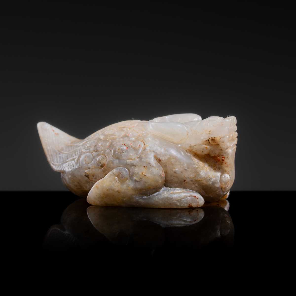 Lot 20 - A MOTTLED WHITE JADE CARVING OF A BIXIE, SIX DYNASTIES PERIOD