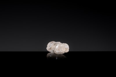 Lot 25 - A CHARMING ROCK CRYSTAL ‘BOY WITH LOTUS’ PENDANT, LIAO DYNASTY