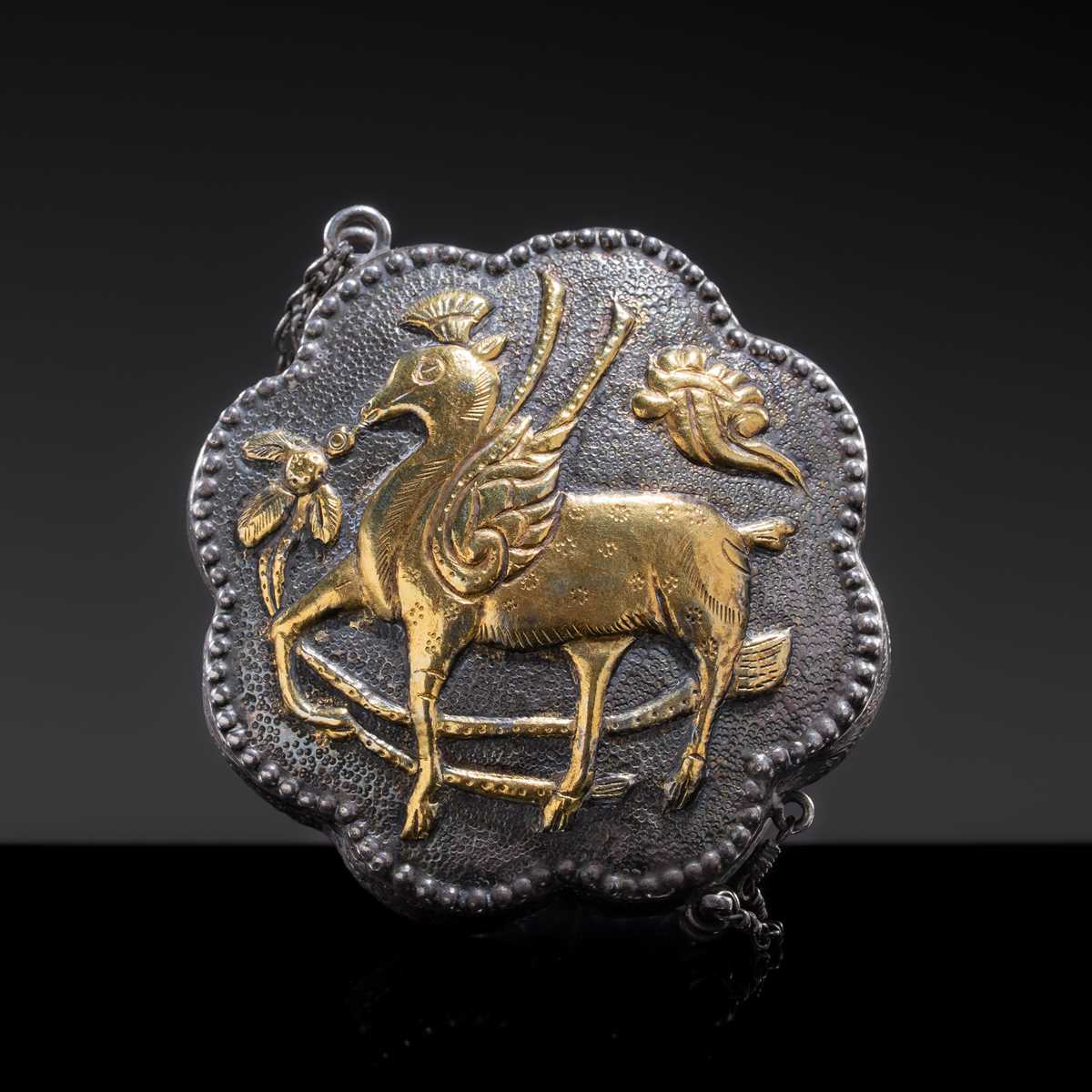 Lot 13 - A MINIATURE PARCEL-GILT SILVER ‘WINGED DEER’ BOX AND COVER, TANG DYNASTY