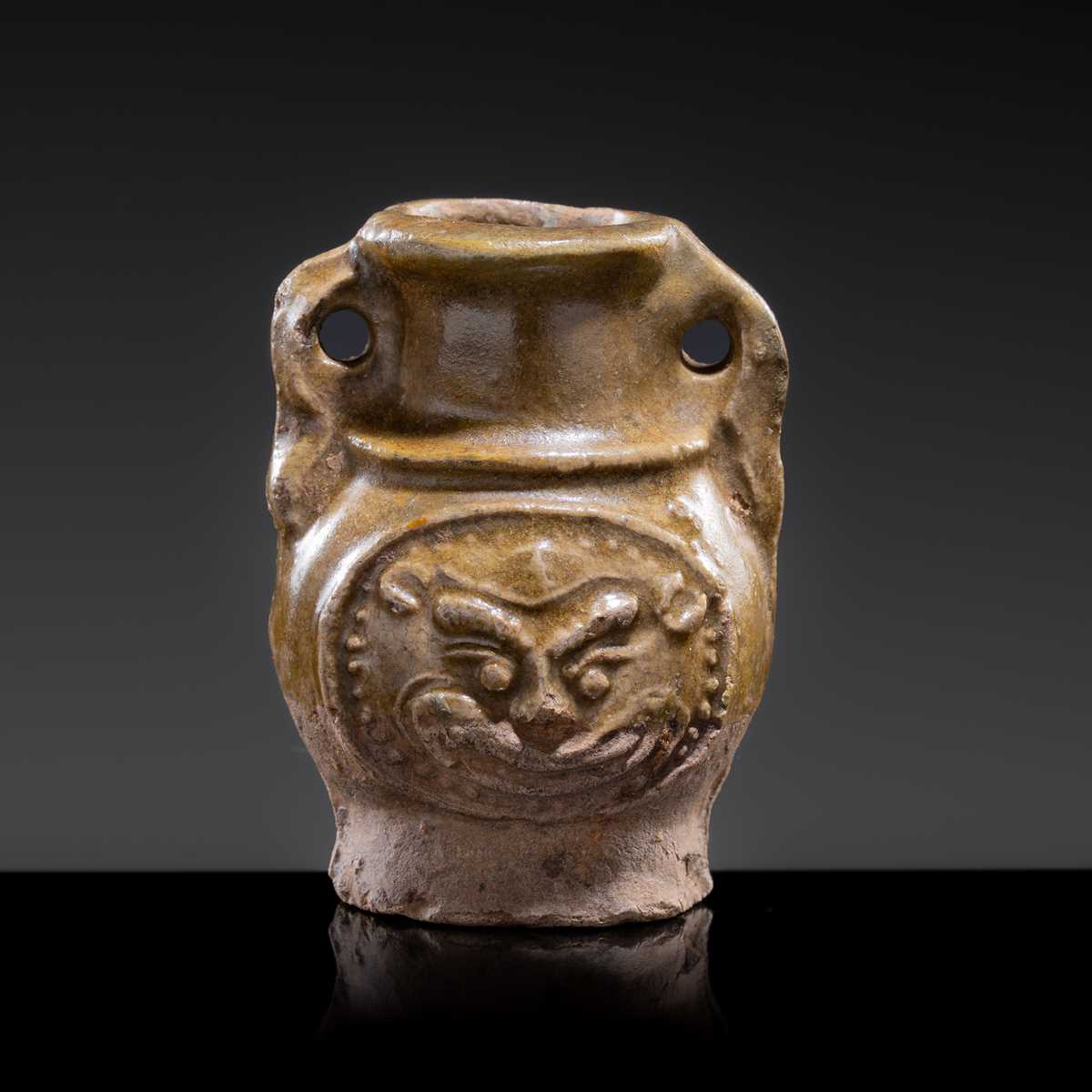 A MINIATURE YUEYAO GREEN GLAZED ‘DEMON MASK’ POTTERY JAR, EASTERN JIN DYNASTY