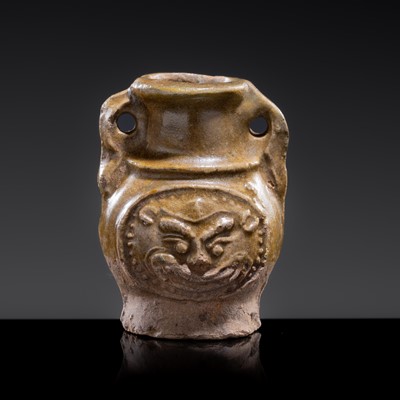 A MINIATURE YUEYAO GREEN GLAZED ‘DEMON MASK’ POTTERY JAR, EASTERN JIN DYNASTY