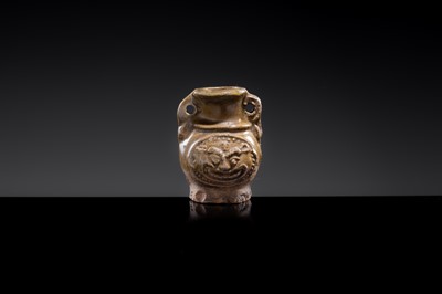 A MINIATURE YUEYAO GREEN GLAZED ‘DEMON MASK’ POTTERY JAR, EASTERN JIN DYNASTY