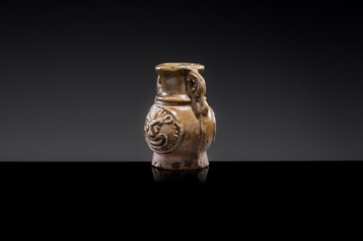 A MINIATURE YUEYAO GREEN GLAZED ‘DEMON MASK’ POTTERY JAR, EASTERN JIN DYNASTY