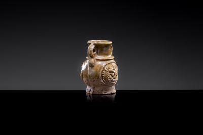 A MINIATURE YUEYAO GREEN GLAZED ‘DEMON MASK’ POTTERY JAR, EASTERN JIN DYNASTY