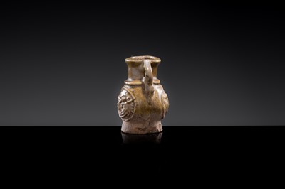 A MINIATURE YUEYAO GREEN GLAZED ‘DEMON MASK’ POTTERY JAR, EASTERN JIN DYNASTY