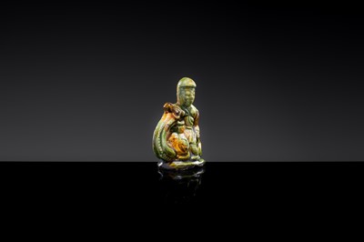 A SANCAI-GLAZED POTTERY FIGURE OF A CAMEL RIDER, TANG DYNASTY