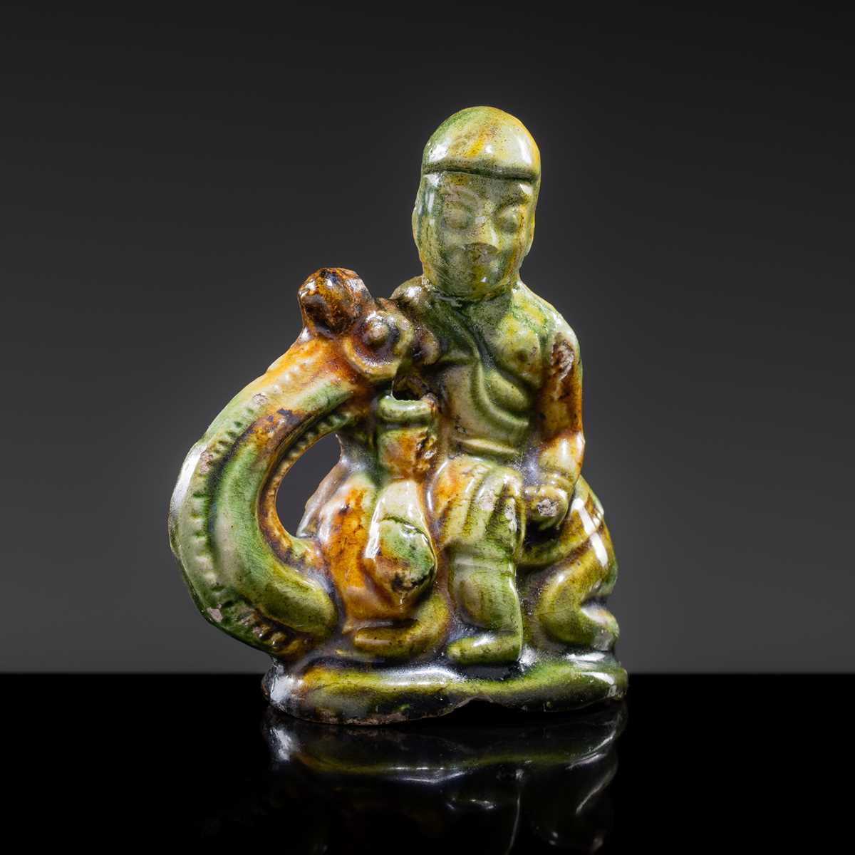 A SANCAI-GLAZED POTTERY FIGURE OF A CAMEL RIDER, TANG DYNASTY
