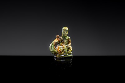 A SANCAI-GLAZED POTTERY FIGURE OF A CAMEL RIDER, TANG DYNASTY