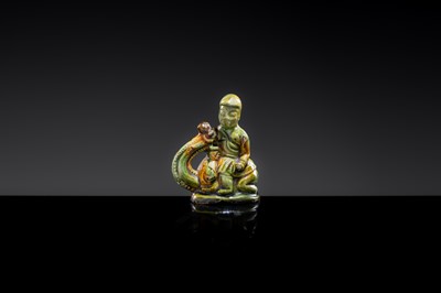 A SANCAI-GLAZED POTTERY FIGURE OF A CAMEL RIDER, TANG DYNASTY