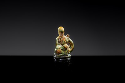 A SANCAI-GLAZED POTTERY FIGURE OF A CAMEL RIDER, TANG DYNASTY