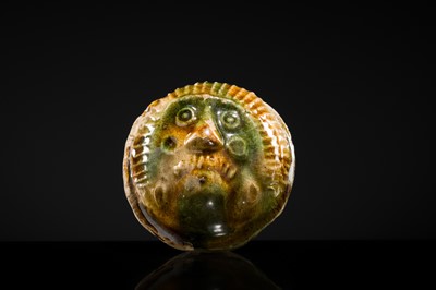 Lot 47 - A SANCAI GLAZED POTTERY ‘MASK’ WHISTLE, TANG DYNASTY