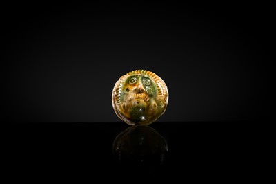 Lot 47 - A SANCAI GLAZED POTTERY ‘MASK’ WHISTLE, TANG DYNASTY